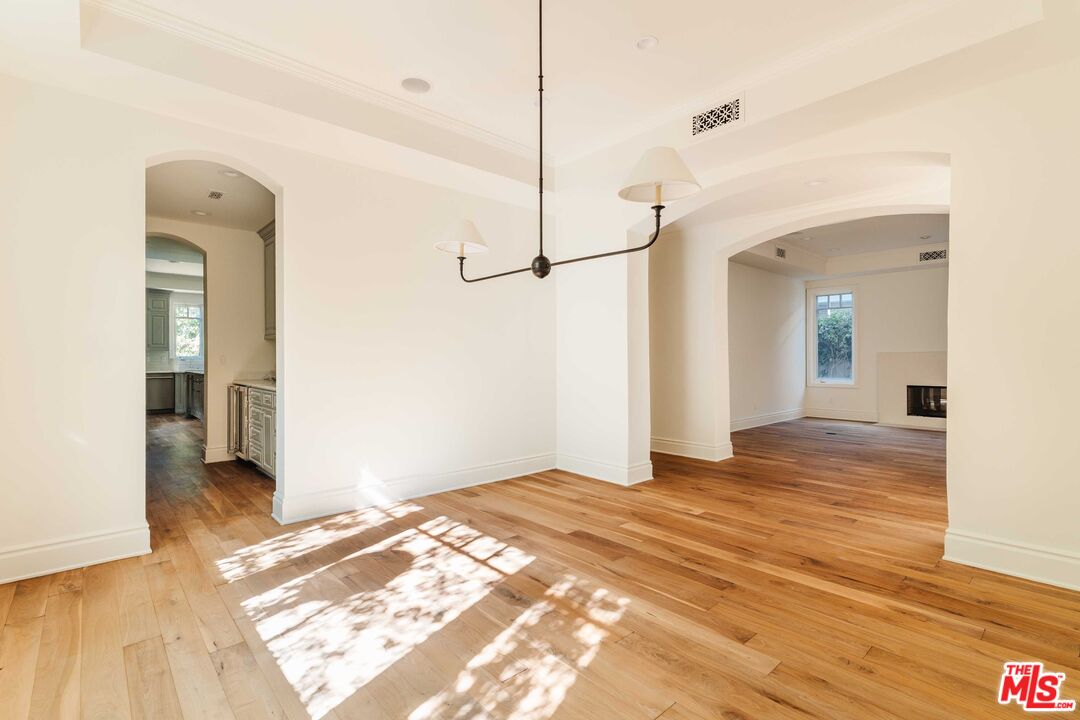 685 San Lorenzo Street Santa Monica, CA 90402 - Photo 16 of 44 a view of a room with wooden floor and a ceiling fan