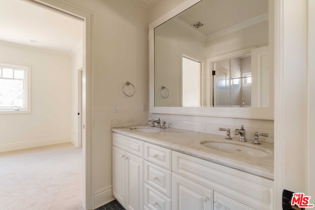 685 San Lorenzo Street Santa Monica, CA 90402 - Photo 33 of 44 a bathroom with a granite countertop sink double and mirror