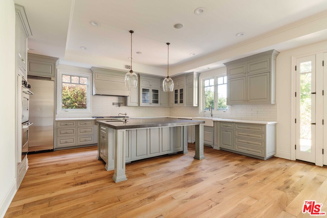 685 San Lorenzo Street Santa Monica, CA 90402 - Photo 10 of 44 a kitchen with stainless steel appliances granite countertop a stove a sink and a refrigerator