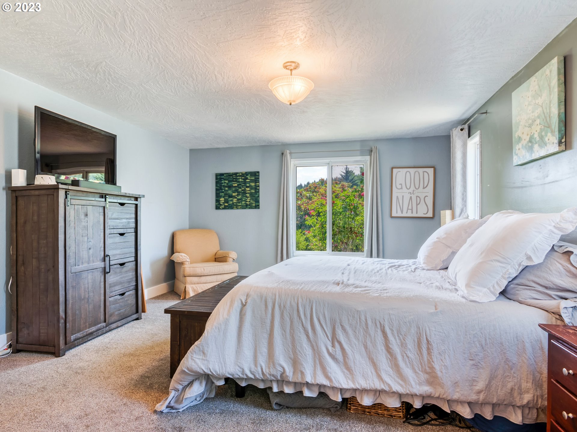 38437 McKenzie Highway Springfield, OR 97478 - Photo 21 of 48 a bedroom with a bed and a flat screen tv