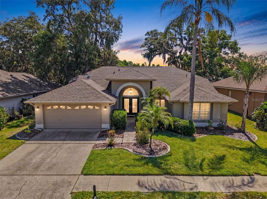 8435 Basuto Drive Trinity, FL 34655 - Photo 1 of 1 a front view of a house with garden