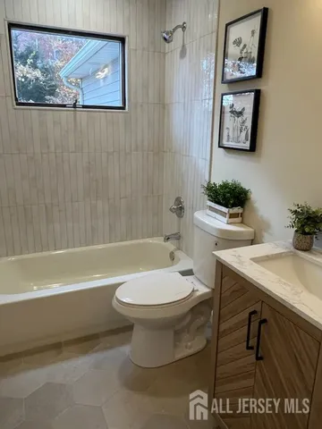 a bathroom with a toilet a sink and bathtub