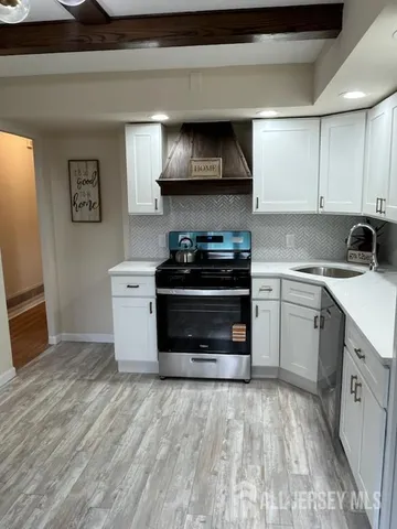 a kitchen with stainless steel appliances a stove and a sink