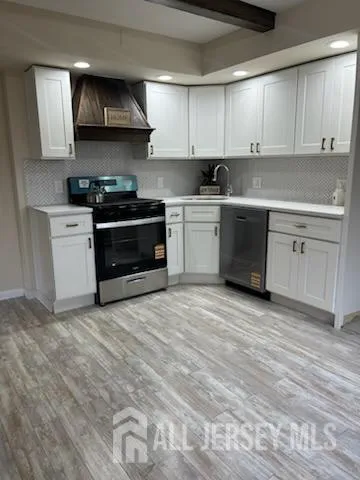 a kitchen with stainless steel appliances a sink and a stove