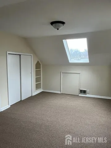 an empty room with a ceiling fan and windows