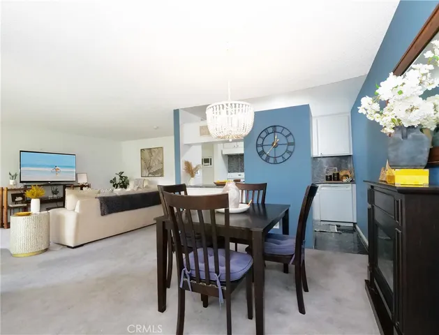 a view of a dining room with furniture and a chandelier