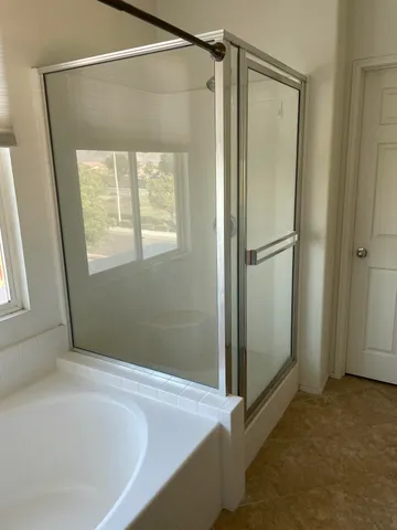 a bathroom with a bathtub and a shower