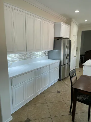 a kitchen with stainless steel appliances granite countertop a refrigerator sink and cabinets