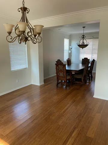 a view of a dining room with furniture window and wooden floor