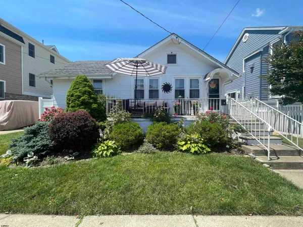 a view of a house with a yard and plants