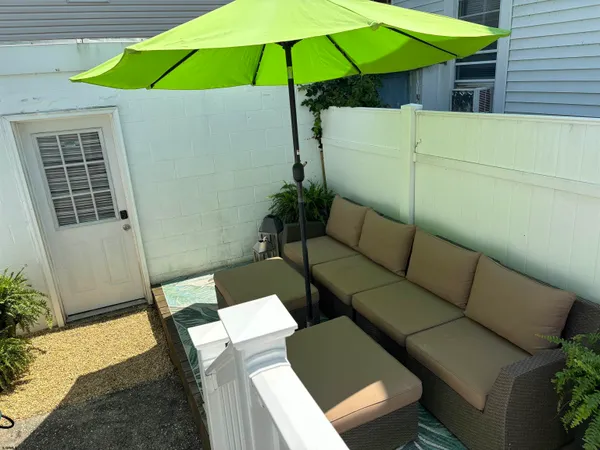 a backyard of a house with table and chairs