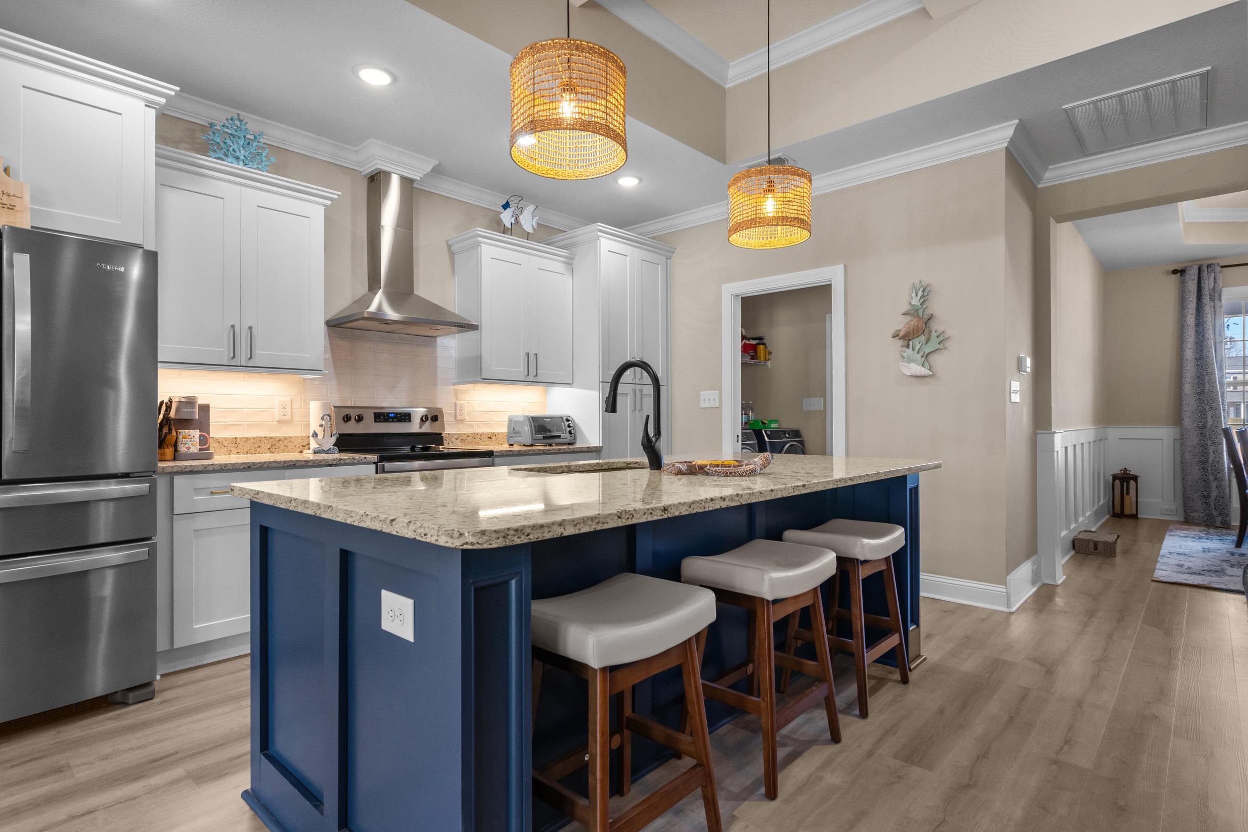 1061 Busy Corner Road Conway, SC 29527 - Photo 13 of 37 Kitchen with light stone countertops, light wood finished floors, a kitchen breakfast bar, blue cabinets, and coffered ceiling