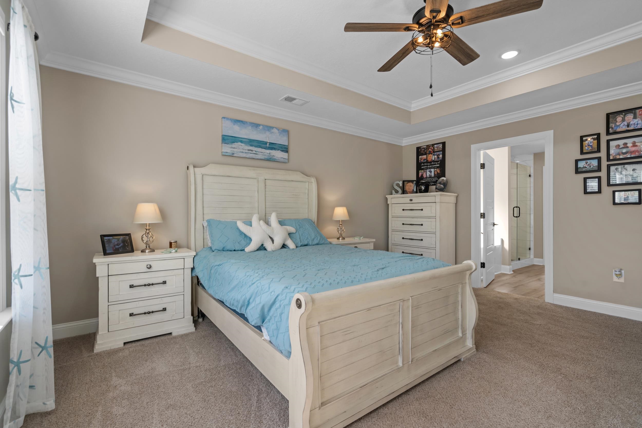 1061 Busy Corner Road Conway, SC 29527 - Photo 18 of 37 Kitchen featuring stainless steel appliances, wall chimney range hood, light stone countertops, light wood-type flooring, and crown molding