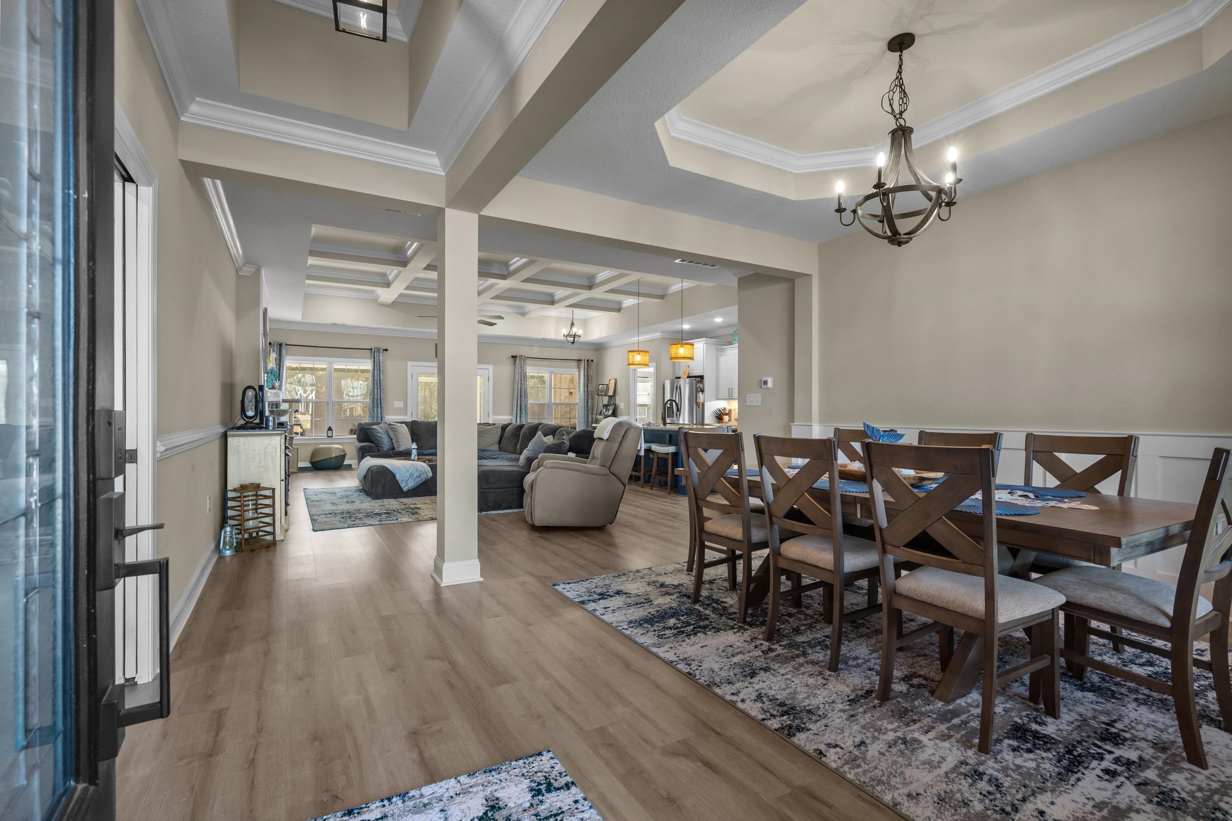 1061 Busy Corner Road Conway, SC 29527 - Photo 4 of 37 Dining space featuring crown molding, wood finished floors, coffered ceiling, and a chandelier