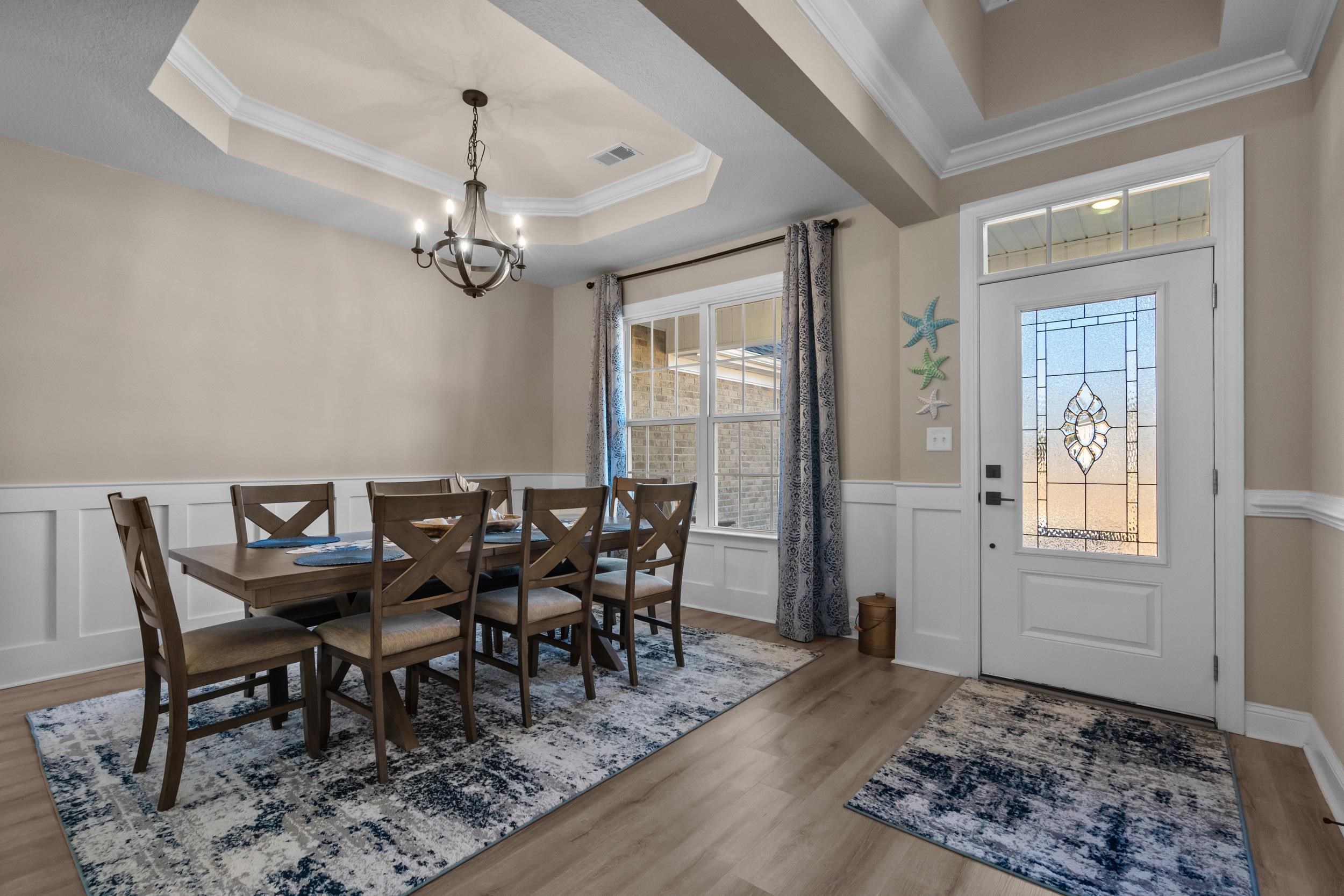 1061 Busy Corner Road Conway, SC 29527 - Photo 5 of 37 Dining room with ornamental molding, a wainscoted wall, light wood-type flooring, a decorative wall, and a tray ceiling
