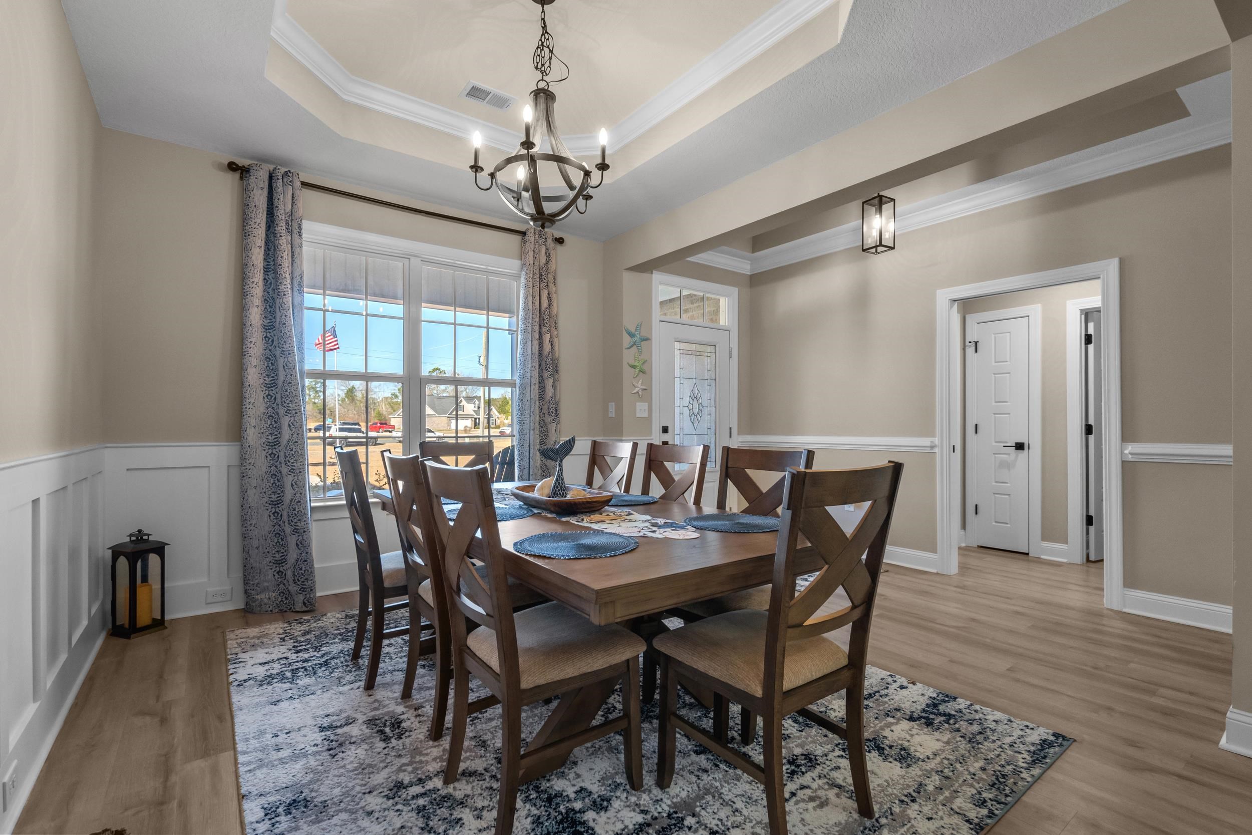 1061 Busy Corner Road Conway, SC 29527 - Photo 6 of 37 Dining space with crown molding, light wood-style flooring, and a chandelier