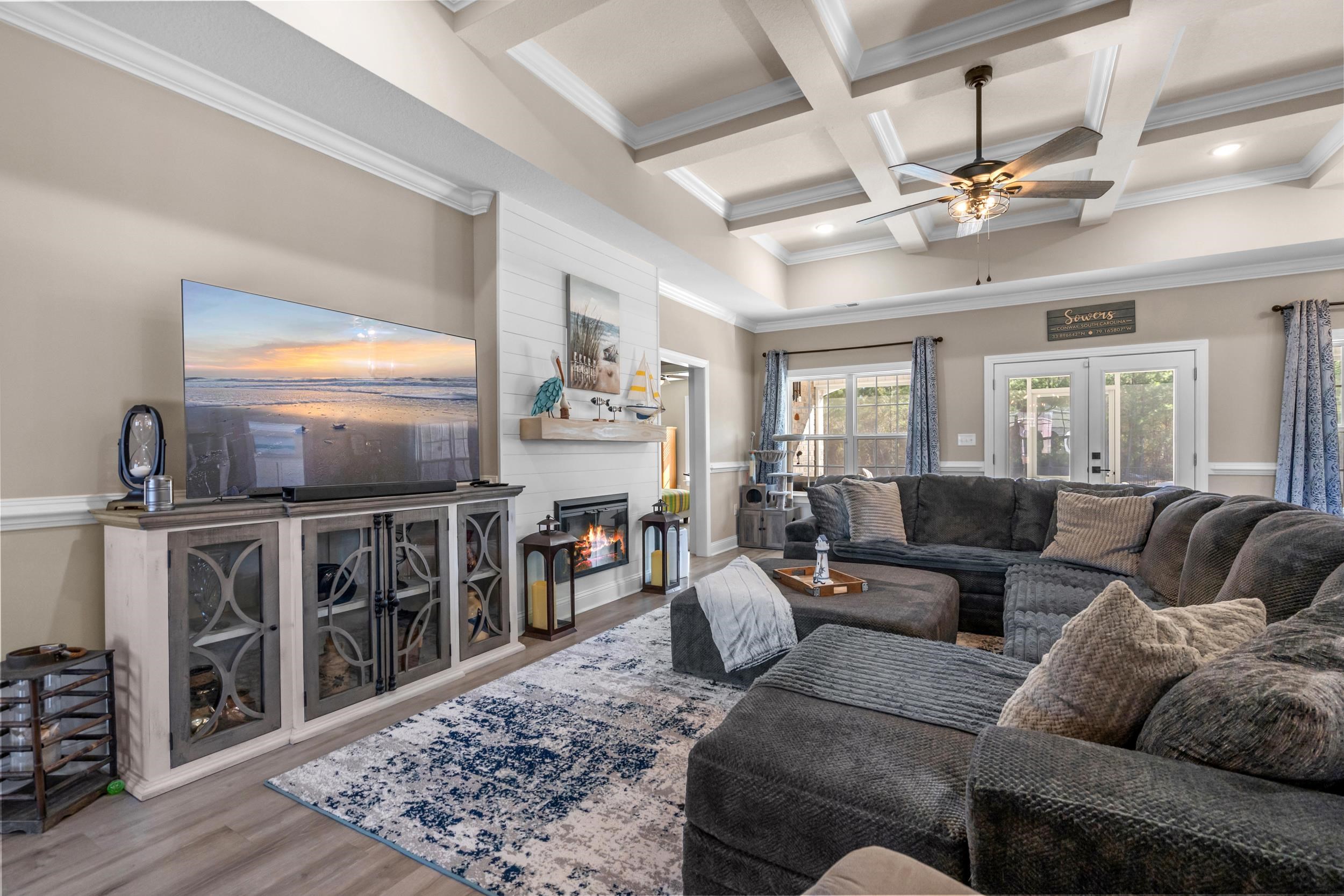 1061 Busy Corner Road Conway, SC 29527 - Photo 9 of 37 Living area featuring a glass covered fireplace, coffered ceiling, wood finished floors, french doors, and ornamental molding