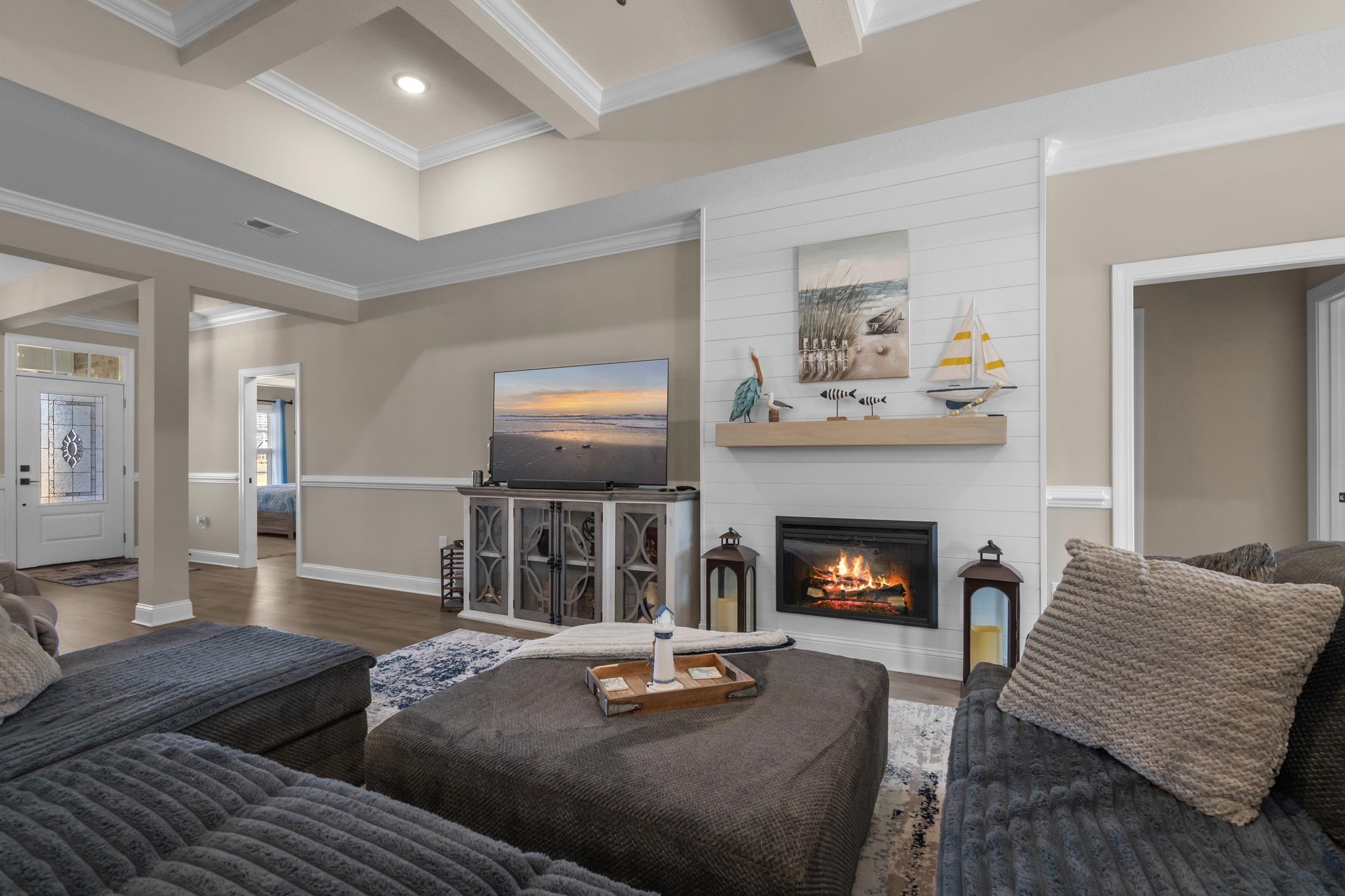 1061 Busy Corner Road Conway, SC 29527 - Photo 10 of 37 Living area with crown molding, a fireplace, wood finished floors, beam ceiling, and recessed lighting