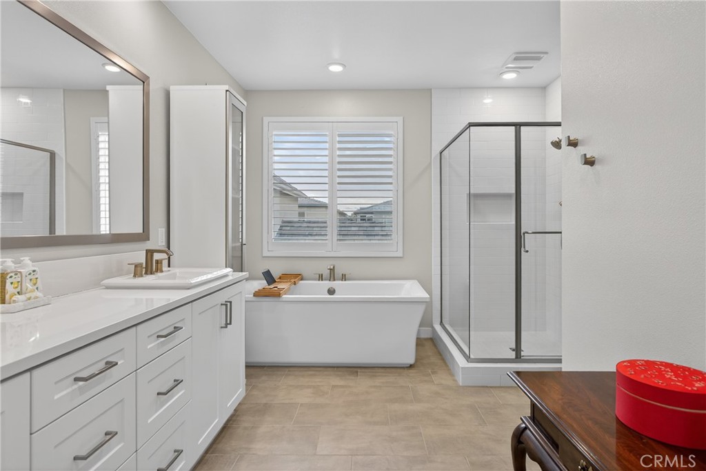 382 Chorus Irvine, CA 92618 - Photo 15 of 38 a spacious bathroom with a double vanity sink mirror and bathtub