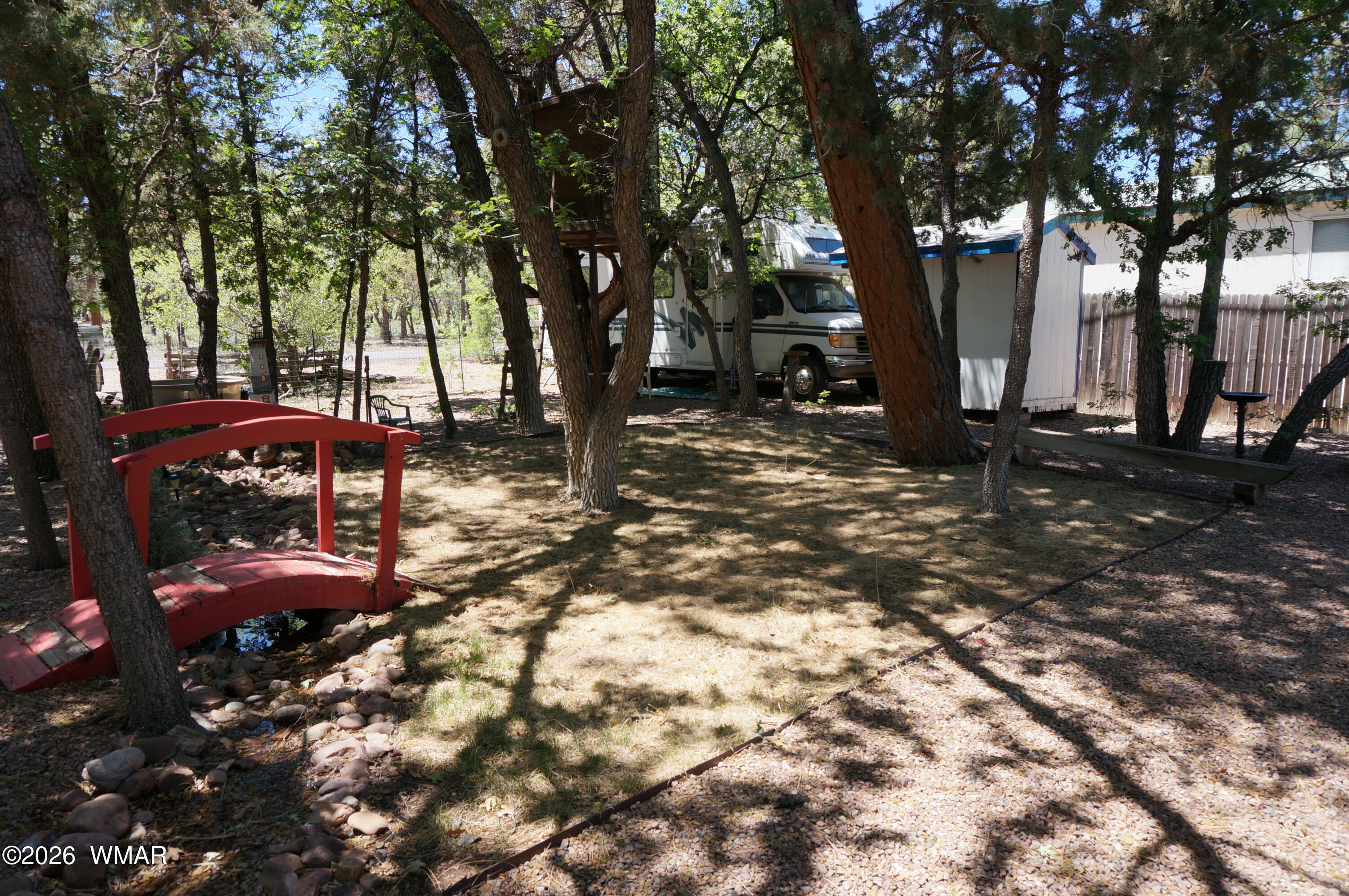 6066 Wagon Wheel Road Lakeside, AZ 85929 - Photo 25 of 32 a backyard of a house with table and chairs