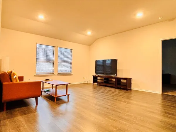 a blue bed sitting in a room next to a window