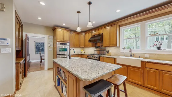 a stove top oven sitting inside of a kitchen