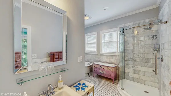 a bathroom with a sink a mirror and a shower