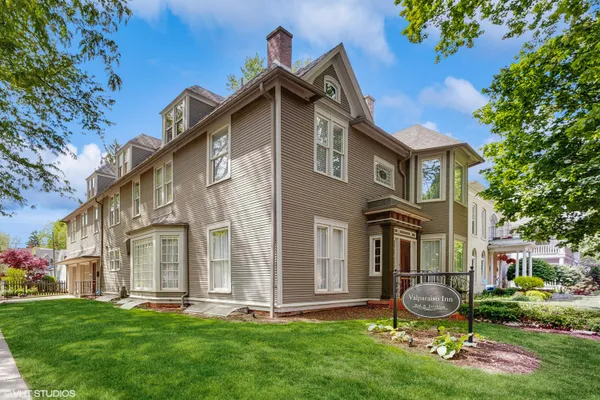 a front view of a house with a yard and porch