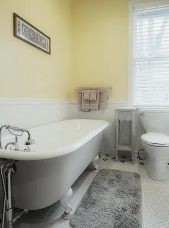 a bathroom with a sink toilet and a mirror