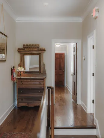 a bedroom with furniture and wooden floor