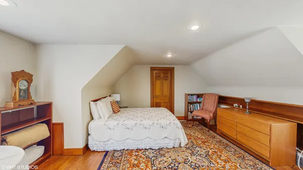 a bed room with bed and a chandelier