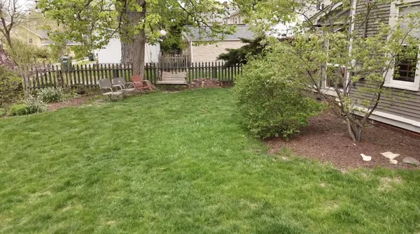 a living room with furniture a rug and a clock