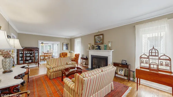 a living room with kitchen island furniture and a chandelier