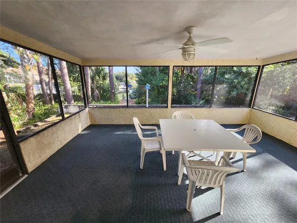 a view of a dining room with furniture large windows and wooden floor