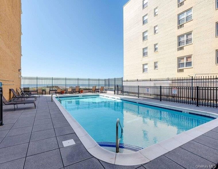 650 Shore Road, Unit 1C Long Beach, NY 11561 - Photo 16 of 21 a view of a swimming pool with a terrace