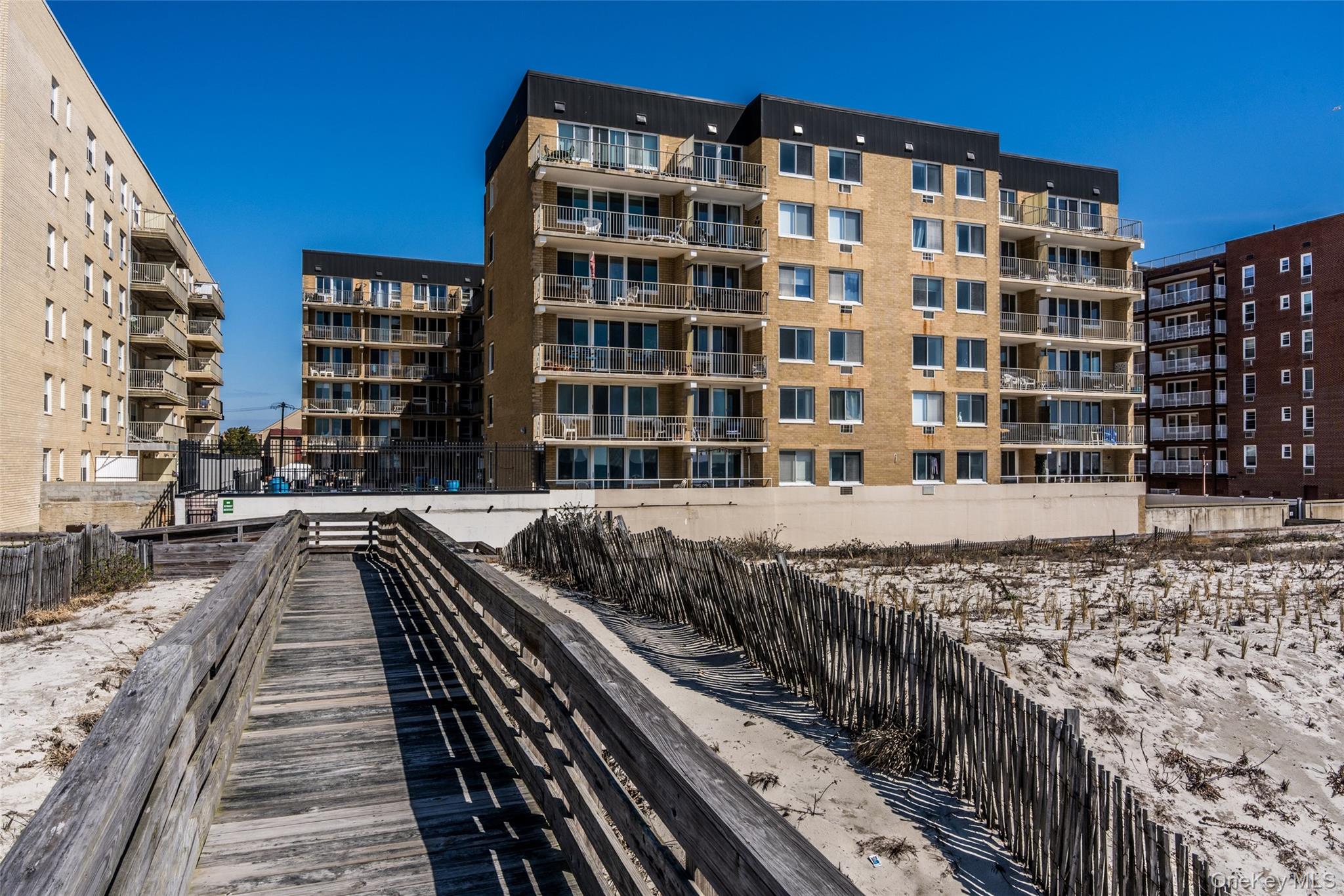 650 Shore Road, Unit 1C Long Beach, NY 11561 - Photo 18 of 21 a view of swimming pool with building exterior