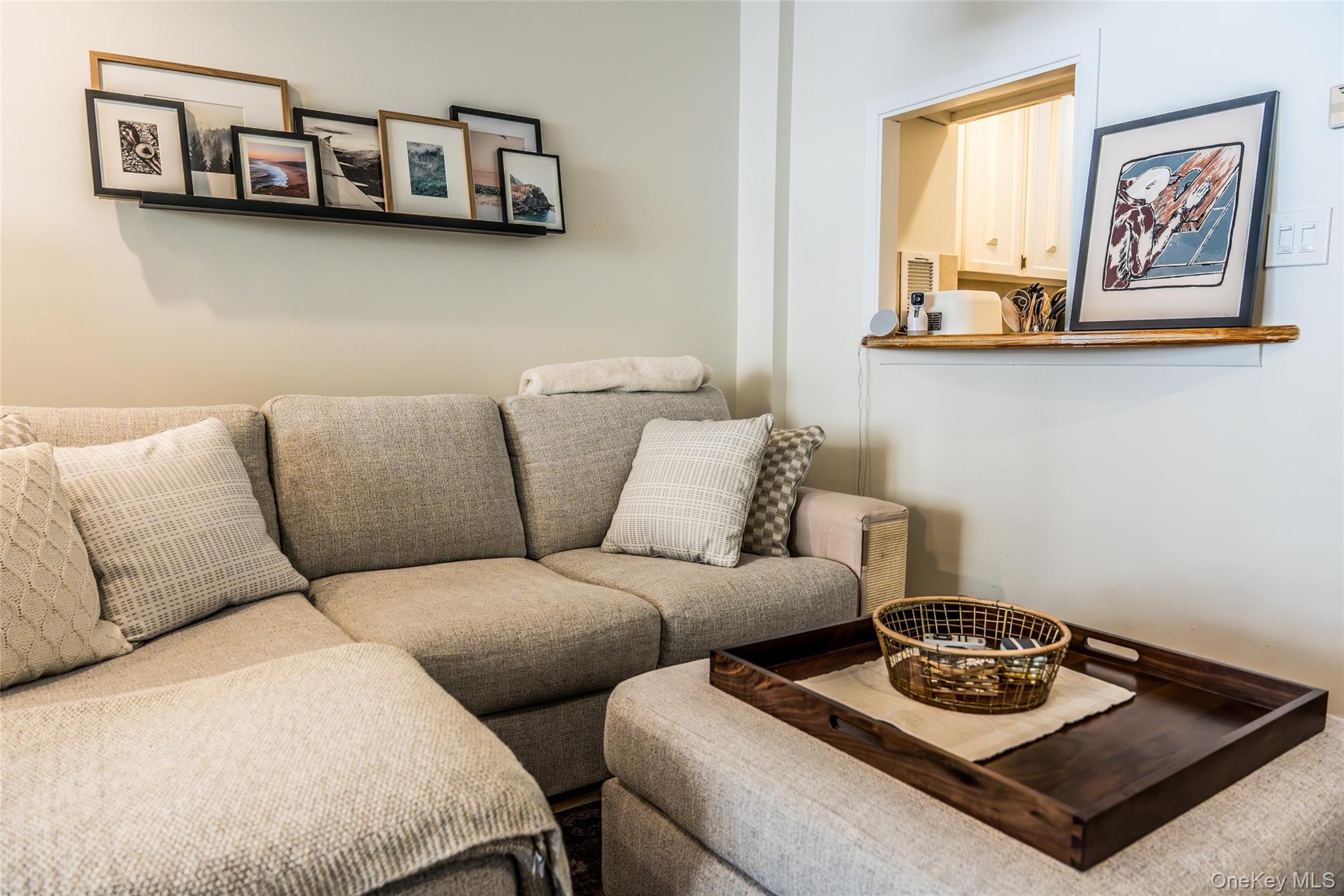 650 Shore Road, Unit 1C Long Beach, NY 11561 - Photo 6 of 21 a living room with furniture and painting on the wall