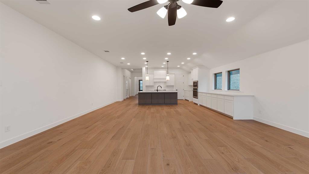 829 Stoney Bridge Way Lavon, TX 75166 - Photo 7 of 35 an empty room with wooden floor and windows