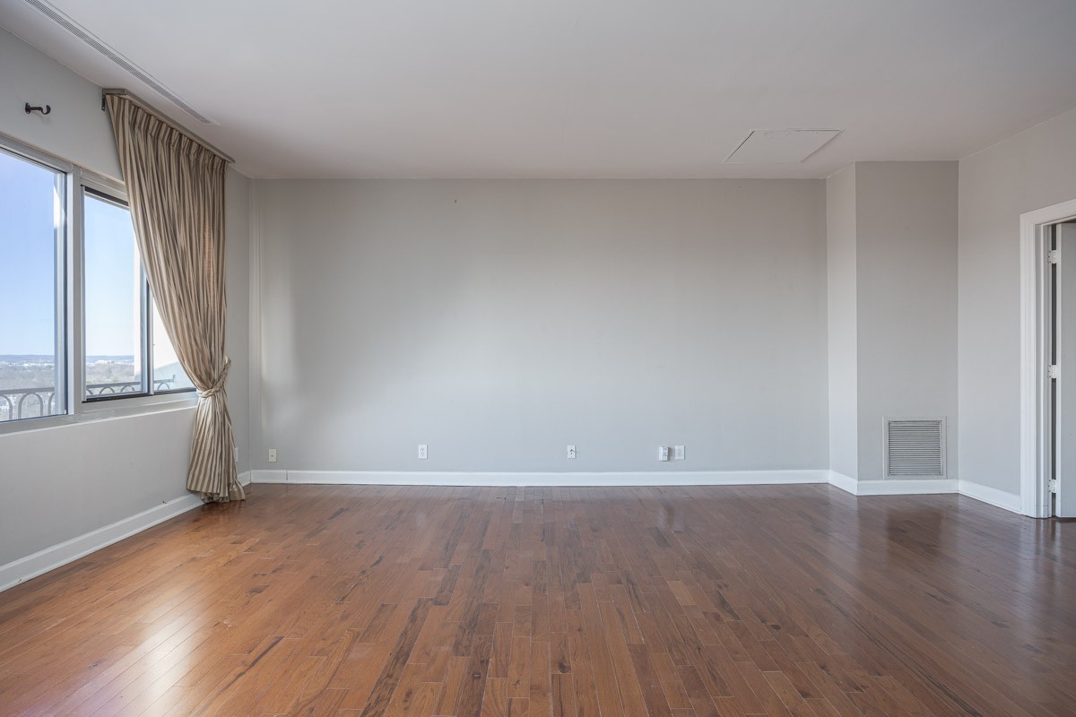 4215 Harding Pike, Unit 1203 Nashville, TN 37205 - Photo 13 of 43 a view of an empty room with wooden floor and a window