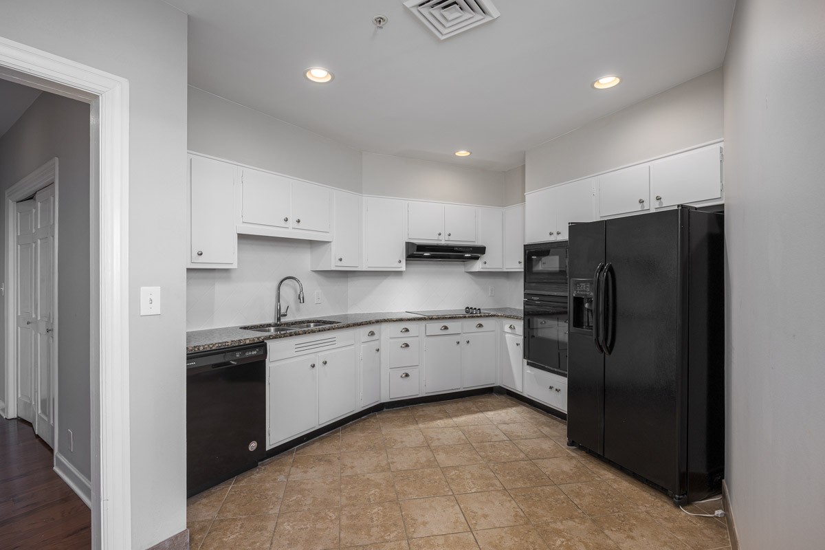 4215 Harding Pike, Unit 1203 Nashville, TN 37205 - Photo 16 of 43 a kitchen with stainless steel appliances granite countertop a refrigerator and a stove