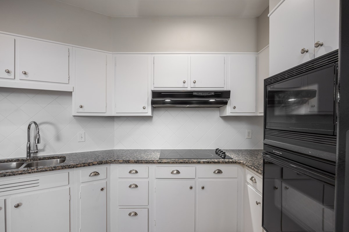 4215 Harding Pike, Unit 1203 Nashville, TN 37205 - Photo 18 of 43 a kitchen with stainless steel appliances granite countertop a sink and a stove