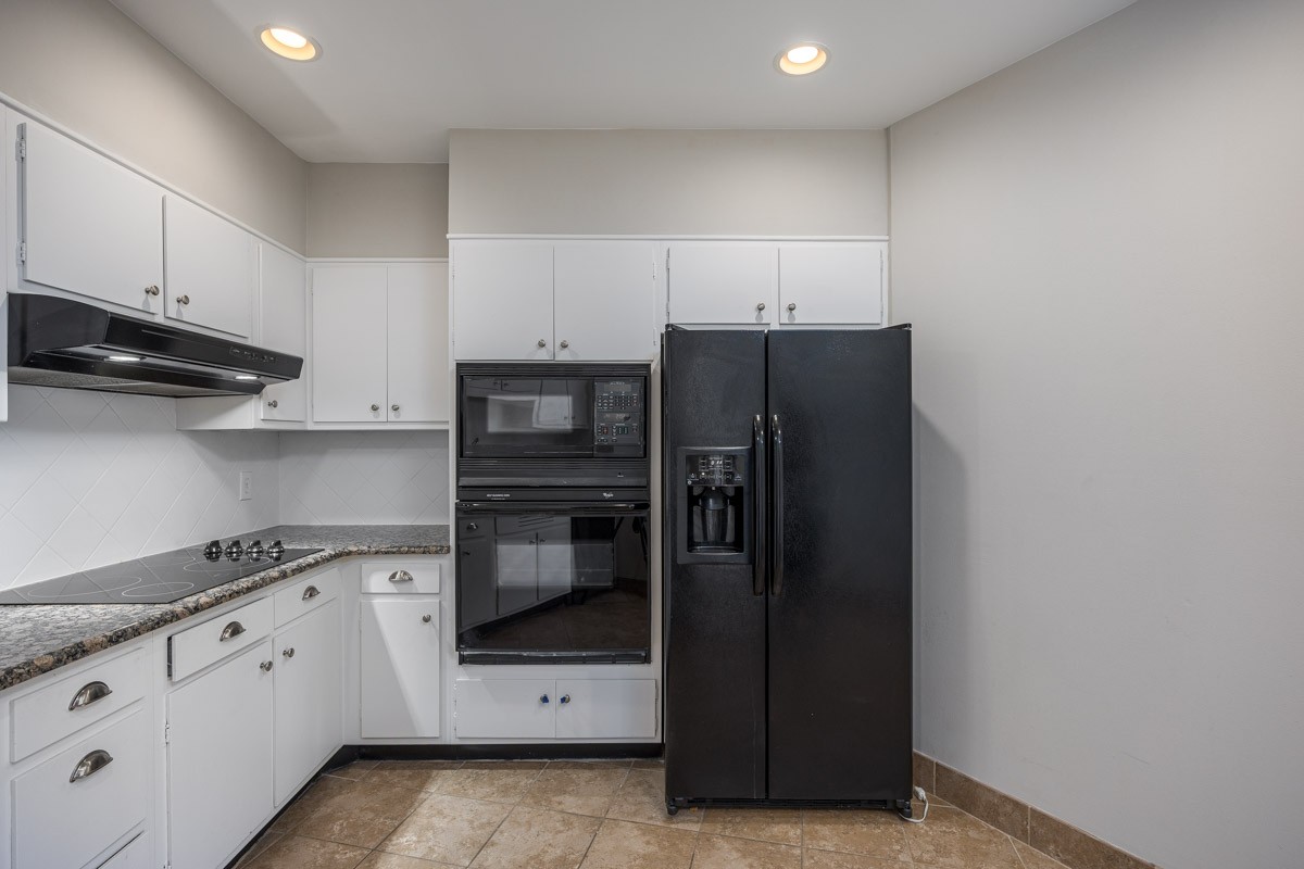 4215 Harding Pike, Unit 1203 Nashville, TN 37205 - Photo 20 of 43 a kitchen with cabinets and stainless steel appliances