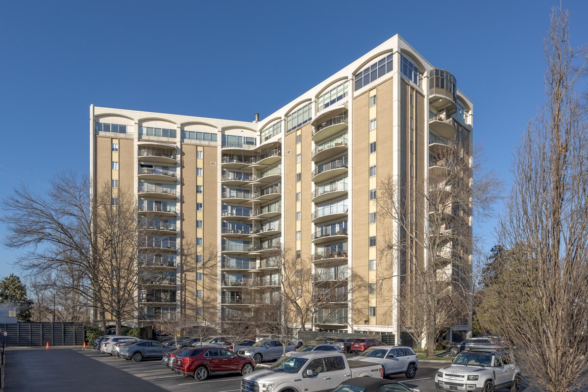 4215 Harding Pike, Unit 1203 Nashville, TN 37205 - Photo 2 of 43 a front view of a building with lot of cars and trees