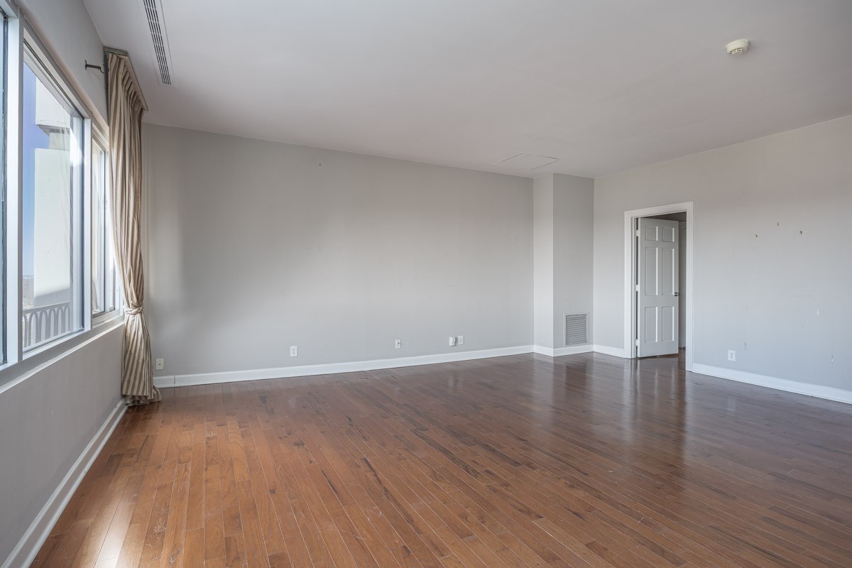 4215 Harding Pike, Unit 1203 Nashville, TN 37205 - Photo 22 of 43 a view of an empty room with wooden floor and a window