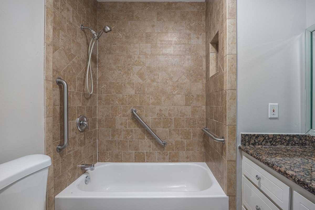 4215 Harding Pike, Unit 1203 Nashville, TN 37205 - Photo 25 of 43 a bath tub sitting next to a white toilet