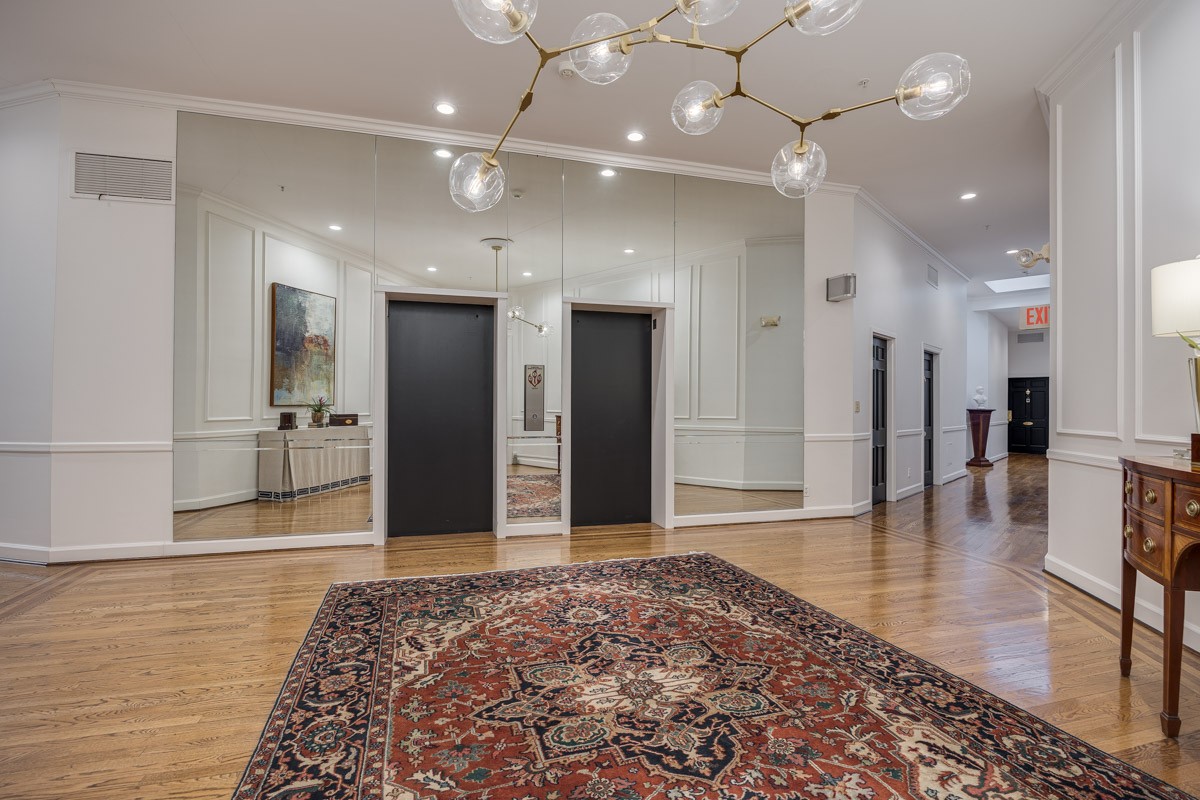 4215 Harding Pike, Unit 1203 Nashville, TN 37205 - Photo 8 of 43 a view of a hallway with wooden floor and a large mirror
