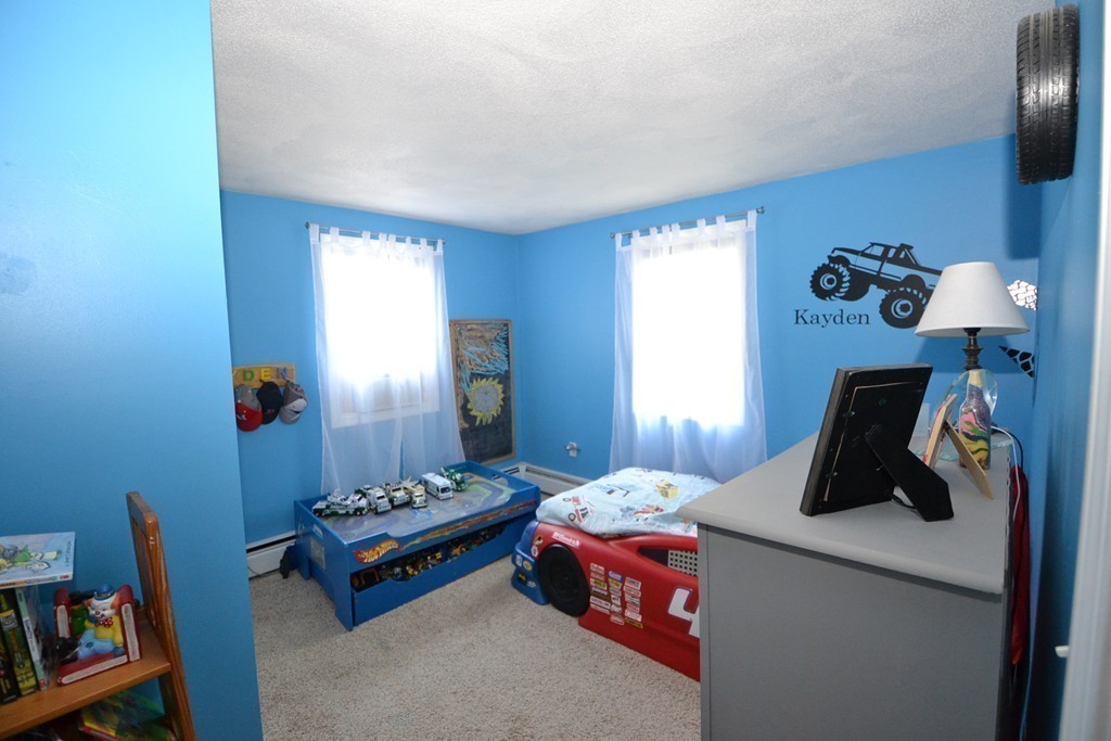 395 Mendon Road North Attleboro, MA 02760 - Photo 12 of 14 a bedroom with bed and a chandelier