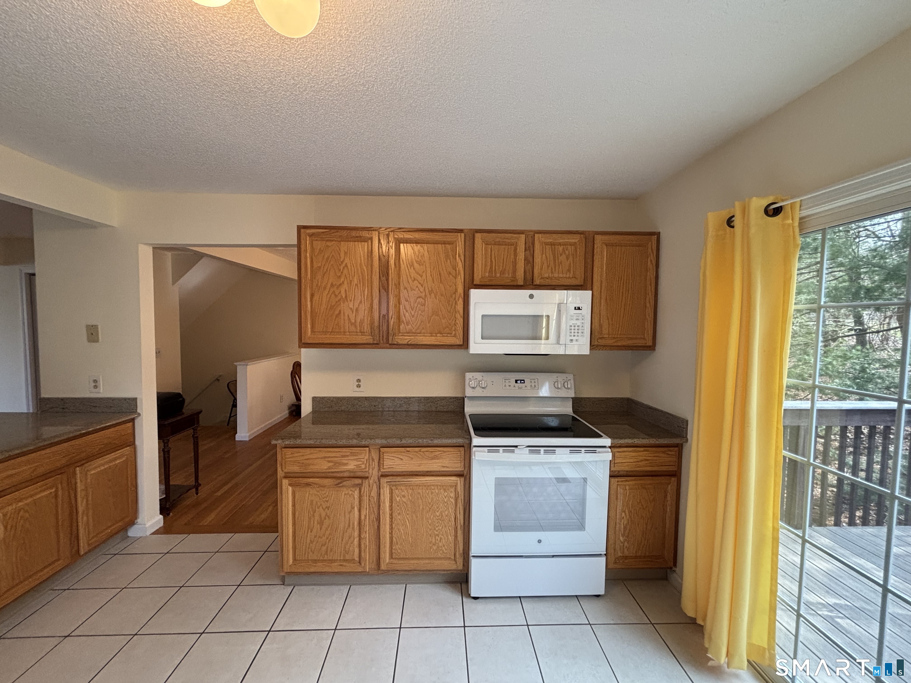 83 Danny's Way, Unit 83 Wallingford, CT 06492 - Photo 12 of 38 a kitchen with a stove sink and cabinets
