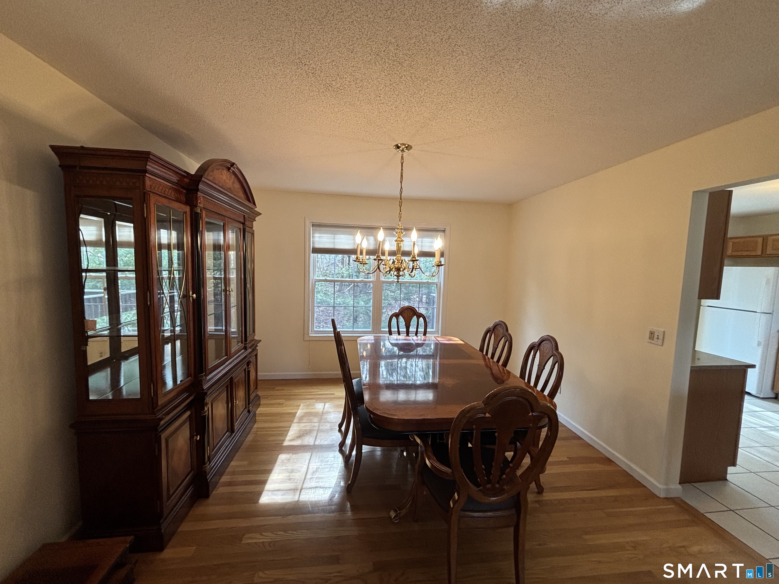 83 Danny's Way, Unit 83 Wallingford, CT 06492 - Photo 14 of 38 a view of a dining room with furniture window and wooden floor