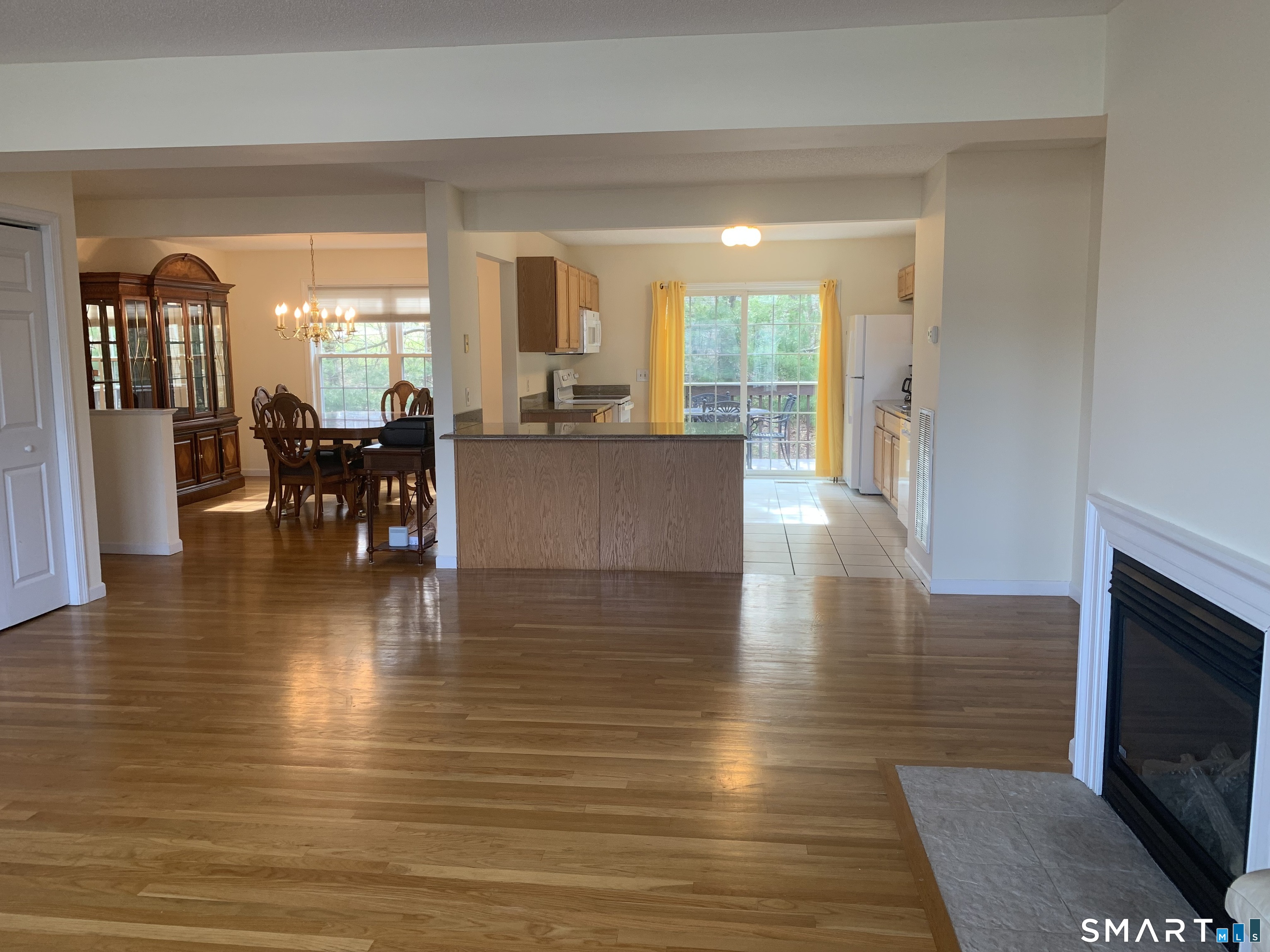 83 Danny's Way, Unit 83 Wallingford, CT 06492 - Photo 17 of 38 a view of a living room kitchen with furniture and wooden floor